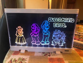 Reviewer's photo showing their drawing illuminated on the light board