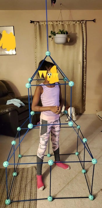 presents 3 year olds reviewer photo of their child standing inside of a fort