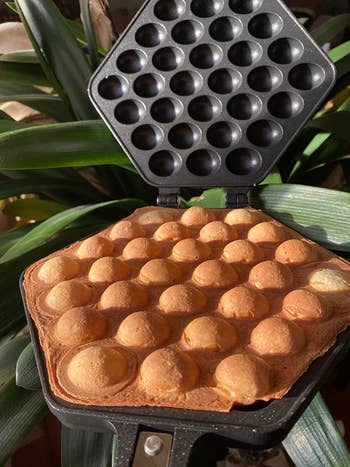 Reviewer's waffle maker with cooked bubble waffle in it