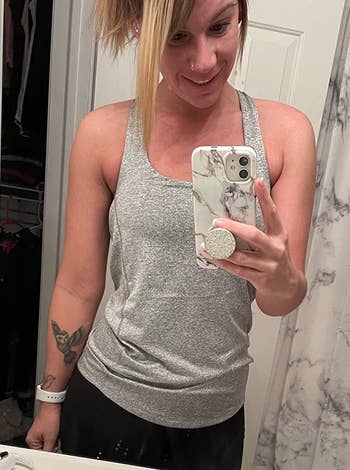 reviewer wearing a gray tank top and black leggings