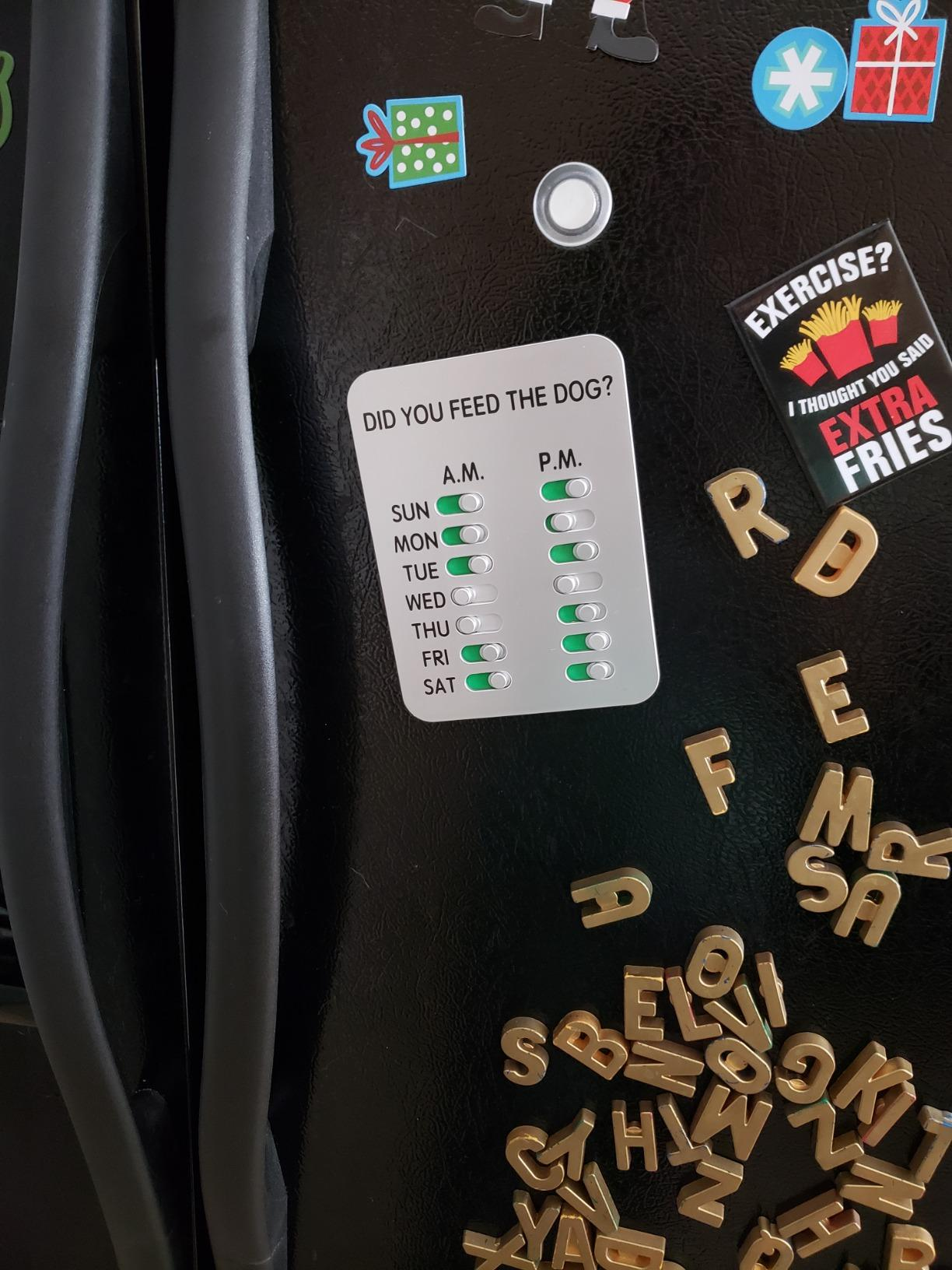 reviewer photo showing the dog food tracker on their fridge 