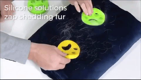 Gif of person cleaning pet hair off a blanket with the two silicone tools