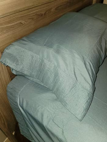 A neatly made bed with textured bedding a