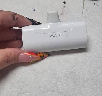 a reviewer holding the charging unit in white 