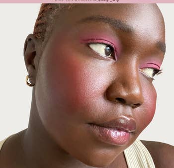 a close up of a model wearing the berry shadow