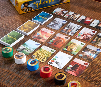 playing cards and gem tiles laid out on a table 
