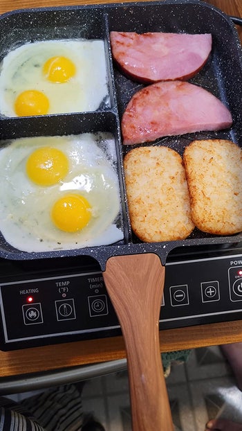 Reviewer using pan on stove to cook breakfast