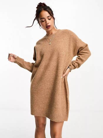model wearing the beige sweater dress
