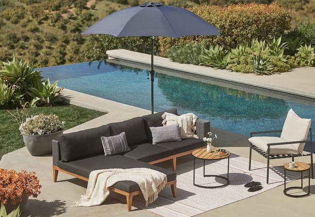 the sectional with dark gray cushions next to a pool 