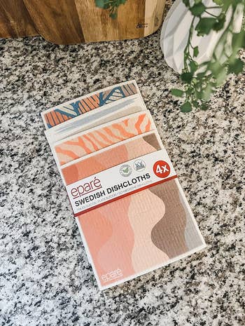 Package of Eparé Swedish Dishcloths, 4-pack, with geometric and abstract patterns displayed on a kitchen countertop