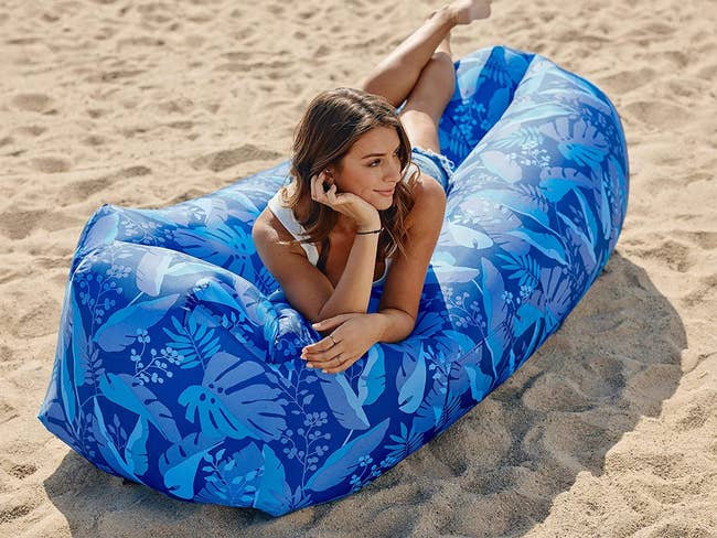 model on an inflated long lounger