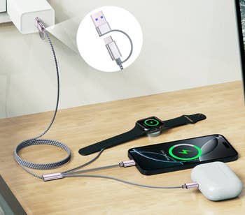 Phone, smartwatch, and earbuds charging connected  a woody  aboveground  with braided cables connected to a USB plug successful  a partition  outlet