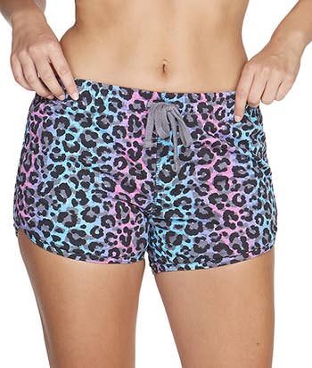 model wearing the super short shorts in blue and pink leopard