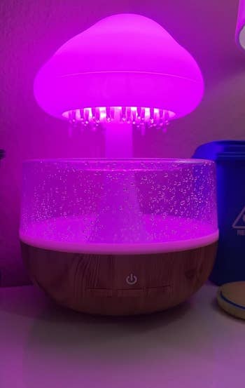 the raining cloud essential oil diffuser glowing pink