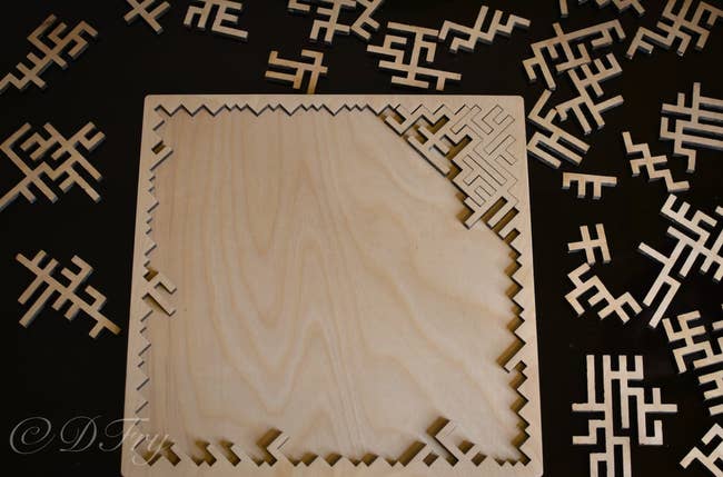 A wooden puzzle made of thin fractals that come together unpredictably 