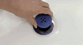 Gif of someone pulling out the TubShroom out of the drain, showing all the hair that it caught