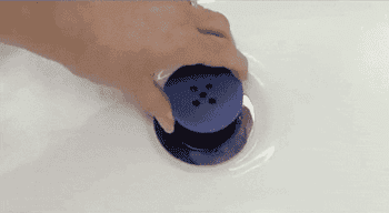 Gif of someone pulling out the TubShroom out of the drain, showing all the hair that it caught