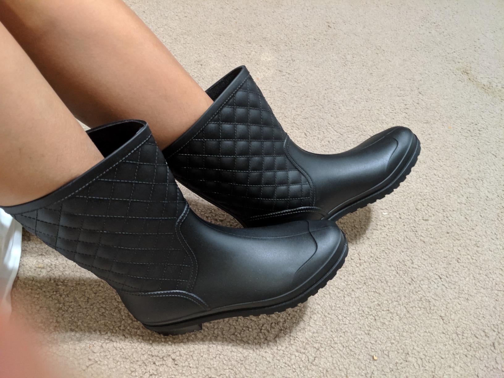 close up of the black rain boots on a reviewer's feet