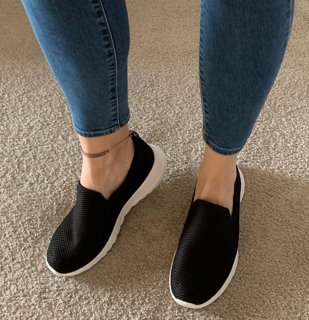 Reviewer photo of the black shoes with white foot beds