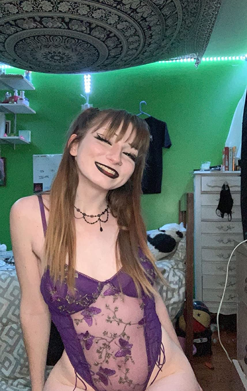 reviewer wearing purple teddy with butterfly embroidery