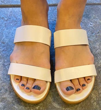Feet in white strap sandals