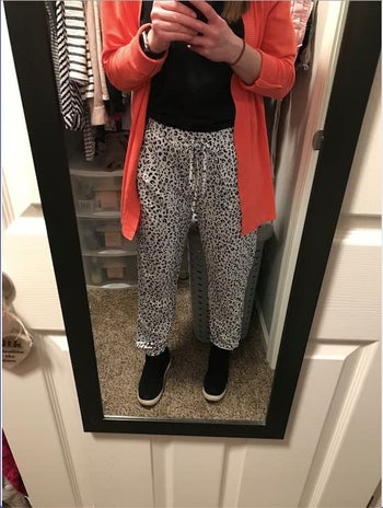 reviewer photo of them wearing the black and white leopard print pants