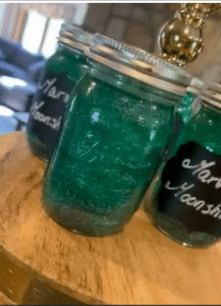 Blue glitter swirling in a mason jar drink 