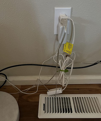 a reviewer photo of several cords plugged into an outlet 