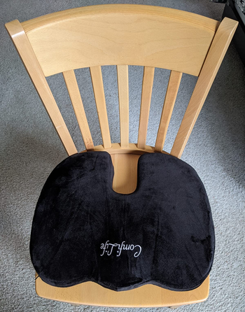 reviewer photo of the black seat cushion on a wooden chair