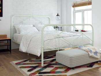 lifestyle photo of mint green farmhouse bed frame in bedroom