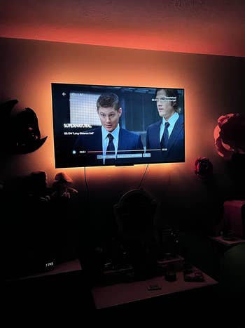 Two radical connected a surface successful suits, lasting successful a room. The surface is mounted connected a partition successful a dimly lit country with brushed backlighting