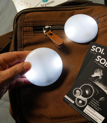 Small moon shaped lights on top of a purse