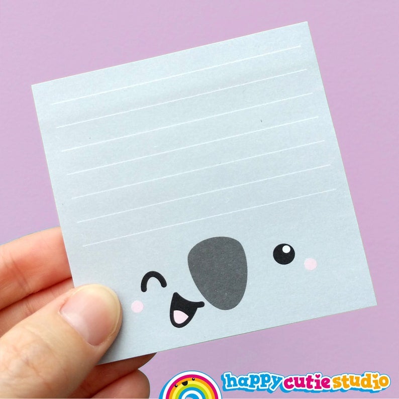 gray lined sticky note pad with winking koala face at the bottom