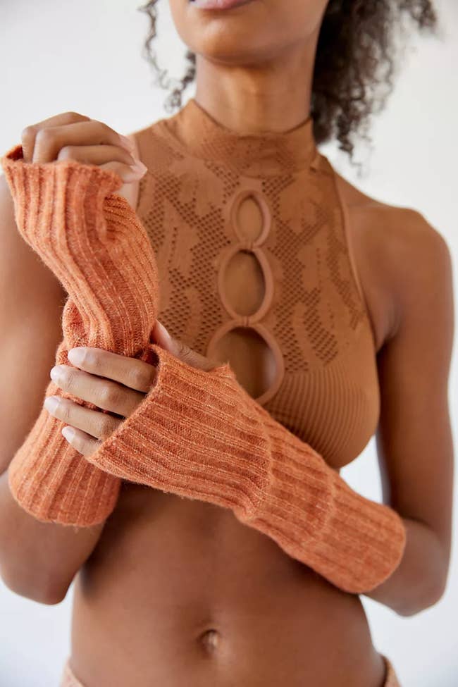 a model wearing orange gloves