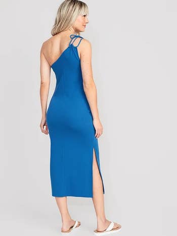 model wearing the blue one shoulder dress and shown from the back