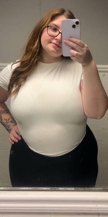 Person taking a reflector selfie successful casual achromatic apical and achromatic pants