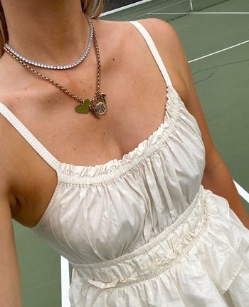 a model wearing the tennis necklace with another Hart Hagerty necklace