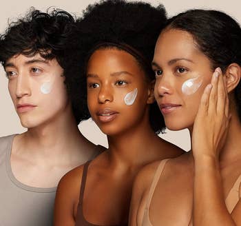 three models with the cream swatched on their cheeks