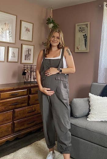 pregnant reviewer wearing the gray overalls