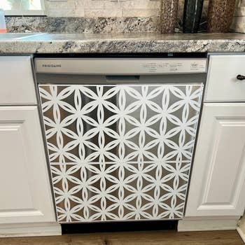 the dishwasher with a white magnetic cover on it