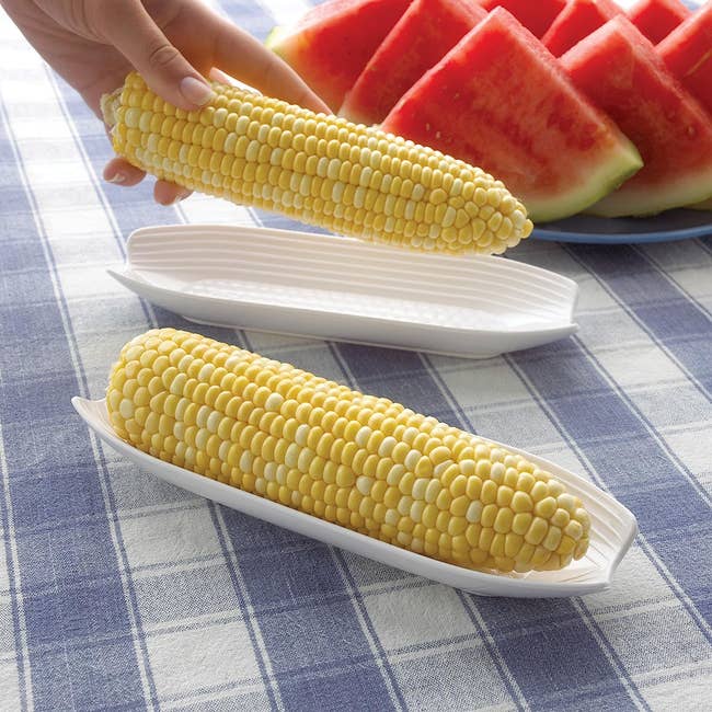 two ears of corn on corn shaped dishes