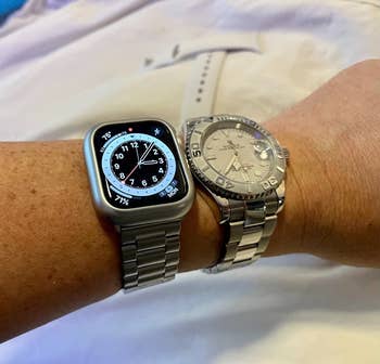 Reviewer with apple watch with band in the color silver next to Rolex watch on arm