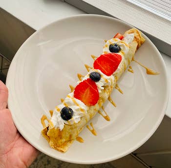 reviewer rolled crepe with whipped cream and fruit detail