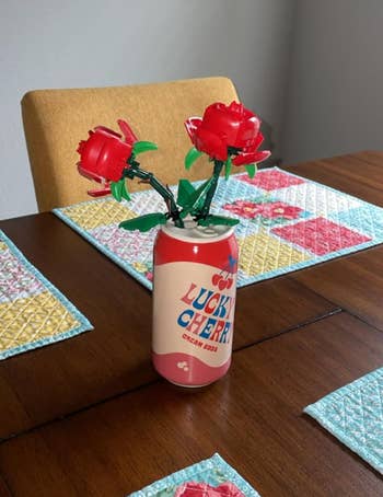 Artificial flowers successful  a soda tin  connected  a eating  array  with quilted placemats