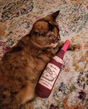 tripod calico with the large wine bottle toy