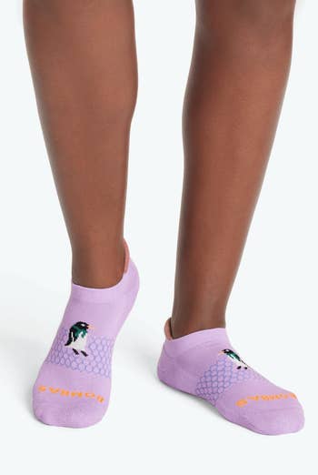 model wearing the purple penguin socks