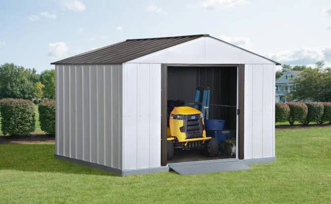 storage shed with lawnmower in it 