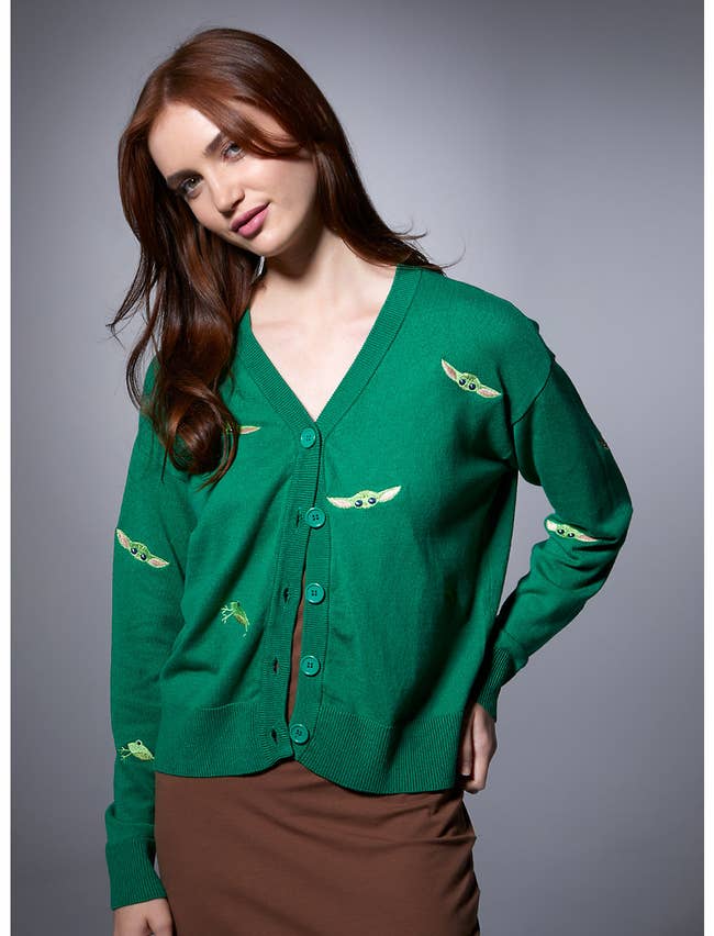 model in green cardigan with embroidered frogs and grogu faces
