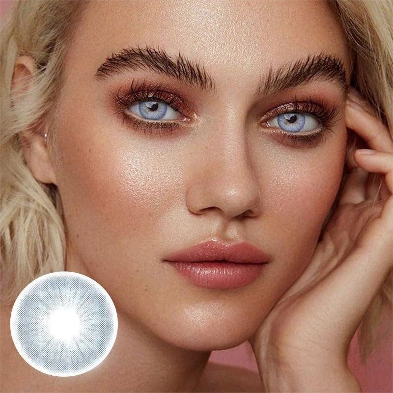 Model with blonde hair wearing light blue contacts with product close up in bottom left corner 