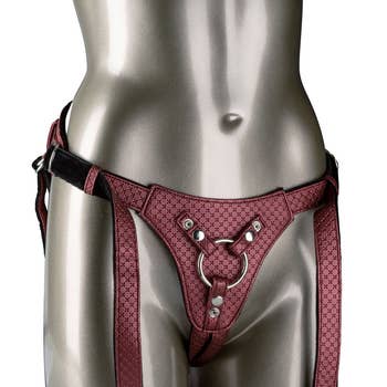 Mannequin with red faux leather harness